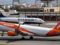 An easyJet aircraft moves past a Ryanair airplane in Portugal.