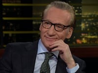 Real Time host Bill Maher sits on set of his HBO tv show.