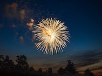 Fireworks against colourful twilight sky.