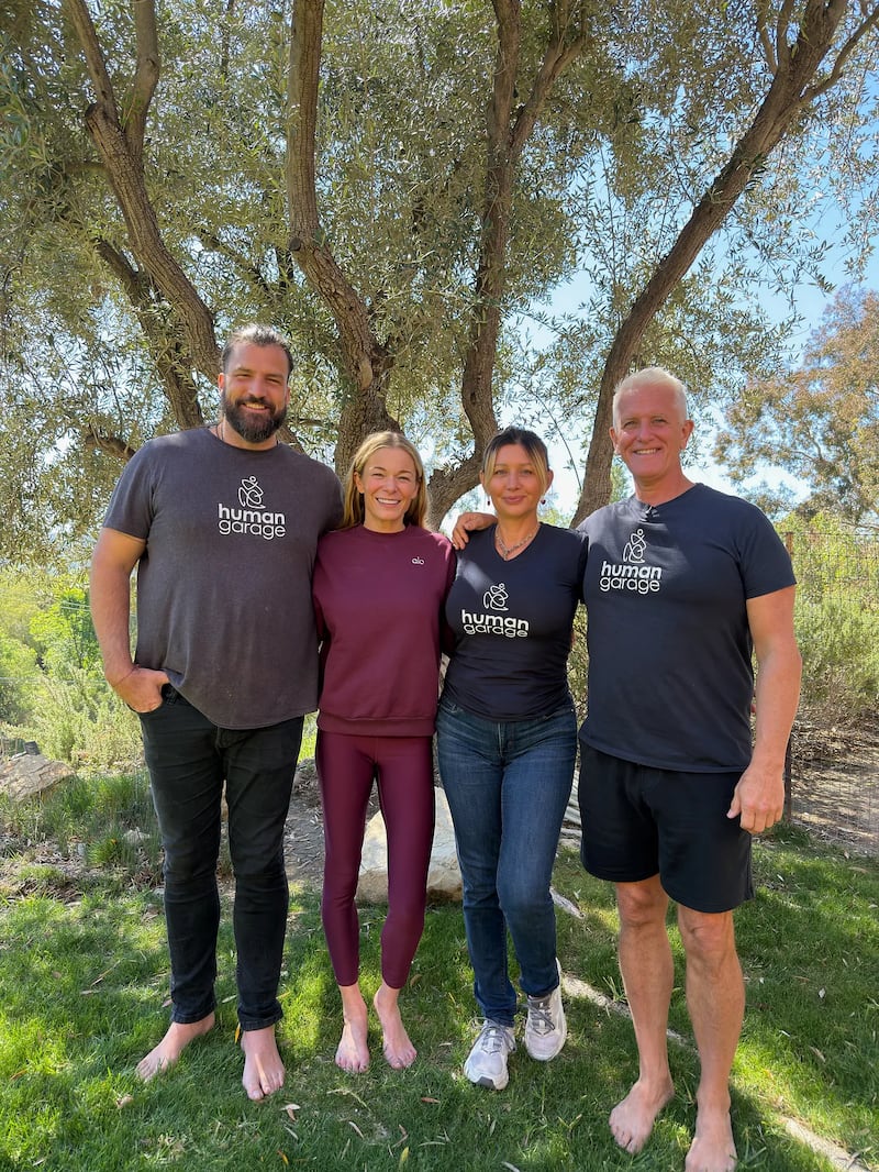LeAnn Rimes standing with Human Garage team of three.