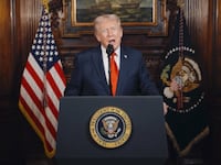 A video screenshot of Donald Trump speaking at a lectern.