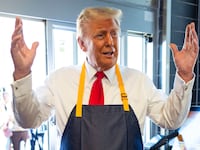 Republican presidential nominee, former U.S. President Donald Trump works behind the counter during a campaign event at McDonald's restaurant on October 20, 2024 in Feasterville-Trevose, Pennsylvania.