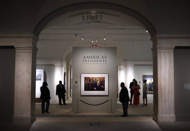 WASHINGTON, DC - MAY 14: Patrons view a portrait of former U.S. President Donald Trump in the America’s Presidents exhibition at the National Portrait Gallery as the Smithsonian Institution begins to slowly re-open its museums May 14, 2021 in Washington, DC. Trump’s portrait, a photograph made by Pari Dukovic is on display to the public for the first time since the closure of the museums due to the coronavirus pandemic. (Photo by Win McNamee/Getty Images)
