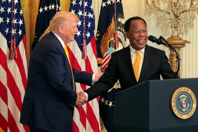 . President Donald Trump shakes hands with attorney Leo Terrell (R) during a Black History Month reception in the East Room of the White House on February 18, 2026 in Washington DC.