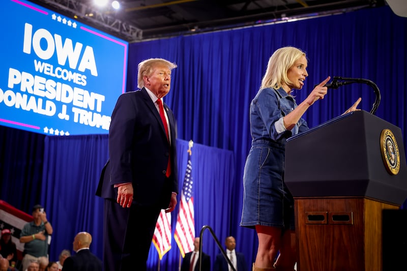 SIOUX CITY, IOWA - OCTOBER 22: Iowa Republican Senate candidate, U.S. Rep. Ashley Hinson (R-IA) (R) speaks after being called up on stage by U.S. President Donald Trump (L) at a rally at Sioux Gateway Airport on October 22, 2026 in Sioux City, Iowa. President Trump traveled to Iowa to rally support for local Republican candidates ahead of the upcoming midterm elections. (Photo by Anna Moneymaker/Getty Images)