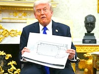 President Donald Trump shows the floor plan of his planned ballroom in the Oval Office of the White House in Washington, DC, on October 22, 2025.