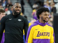 LeBron James (L) #23 and Bronny James #9 of the Los Angeles Lakers warm up before a preseason game against the Golden State Warriors at T-Mobile Arena at T-Mobile Arena on October 15, 2024 in Las Vegas, Nevada.