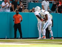Tyreek Hill and Jaylen Waddle celebrating a touchdown during a September 2024 game.