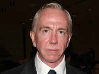 Brent Sikkema stares forward while posing in a suit and tie.