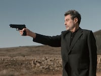 Ian McShane holds a gun up in a still from ‘American Star’