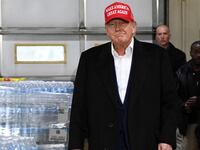 Donald Trump walks past pallets of donated water bottles with a “Trump” label during an event at a fire station to speak about the recent derailment of a train carrying hazardous waste, in East Palestine, Ohio, U.S., February 22, 2023.