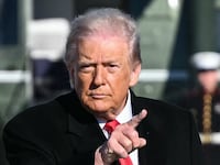 US President Donald Trump gestures as he walks to board Air Force One at Joint Base Andrews, Maryland on January 13, 2026.