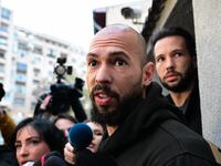 British-US former professional kickboxer and controversial influencer Andrew Tate (front) and his brother Tristan Tate (back R) speak to journalists after having been released from detention in Bucharest, Romania on March 12, 2024,