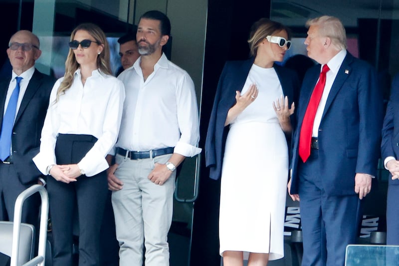 Bettina Anderson, her boyfriend Donald Trump Jr., Melania Trump and Donald Trump at a soccer game last year. Trump Jr. last April co-founded The Executive Branch, where those seeking influence in the Trump administration pay six-figure sums.
