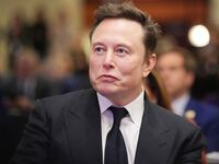 Elon Musk listens as U.S. President-elect Donald Trump addresses a House Republicans Conference meeting at the Hyatt Regency on Capitol Hill on November 13, 2024 in Washington, DC.