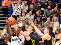 Dallas Mavericks guard Kyrie Irving (11) recovers a rebound over Utah Jazz forward/center Lauri Markkanen (23) during the first half at the Delta Center, Jan. 1, 2024, Salt Lake City, Utah.