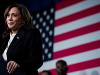 Kamala Harris stands at a podium in front of a U.S. flag.
