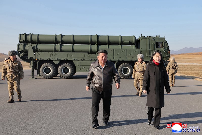 Kim Jong Un and his daughter, Kim Ju Ae, inspect a test firing of a renewed large-caliber rocket-launcher system at an undisclosed location in North Korea.