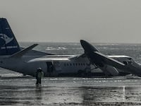 Emergency personnel are seen at the site of the crash of a StarSky airliner after it plunged shorlty after taking off with 55 passengers on board in Mogadishu, on February 10, 2026. (Photo by AFP via Getty Images)