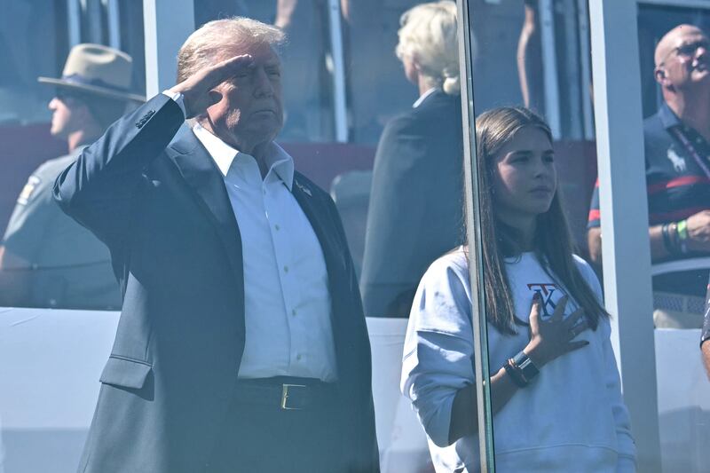 FARMINGDALE, NEW YORK - SEPTEMBER 26: U.S. President Donald Trump, along with his granddaughter Kai Madison Trump, attends the 2025 Ryder Cup at Black Course at Bethpage State Park Golf Course on September 26, 2025 in Farmingdale, New York. In his second term, Trump has attended several major sporting events. (Photo by Mandel Ngan-Pool/Getty Images)
