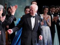 Britain's King Charles reacts as he meets with the cast of a special Gala performance at the Royal Opera House in London.