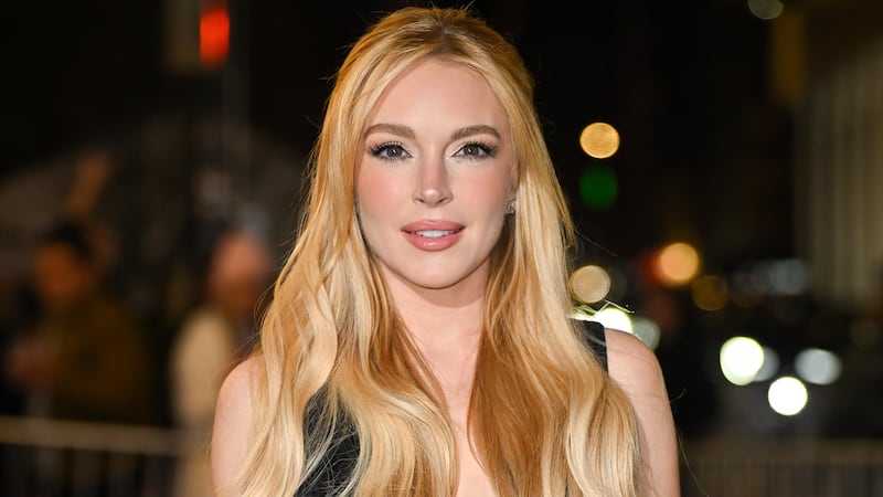 Lindsay Lohan, wearing her blonde hair in loose waves and a half-up hairstyle, attends the Our Little Secret screening at the Paris Theatre on November 18, 2024, in New York City.