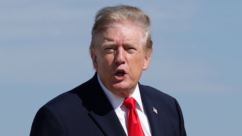 President Donald Trump shouts to the press as he boards Air Force One on October 13, 2026 at Joint Base Andrews, Maryland.