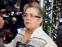 Rosie O'Donnell looking at a camera.
