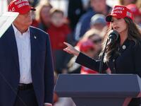 Former US President and Republican presidential candidate Donald Trump listens as North Dakota Governor Kristi Noem speaks during a Buckeye Values PAC Rally in Vandalia, Ohio, on March 16, 2024.