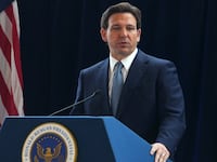Ron DeSantis stands at a podium