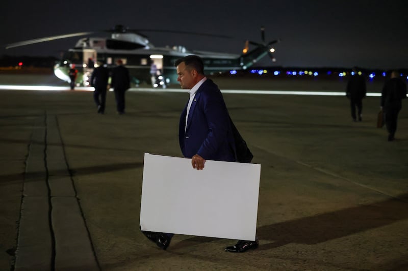 Bill Pulte, director of the U.S. Federal Housing Finance Agency, carries poster boards as he follows President Donald Trump off of Air Force One on September 16, 2026 in Joint Base Andrews, Maryland.
