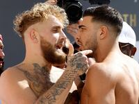 Jake Paul clashes with Tommy Fury during the weigh-in