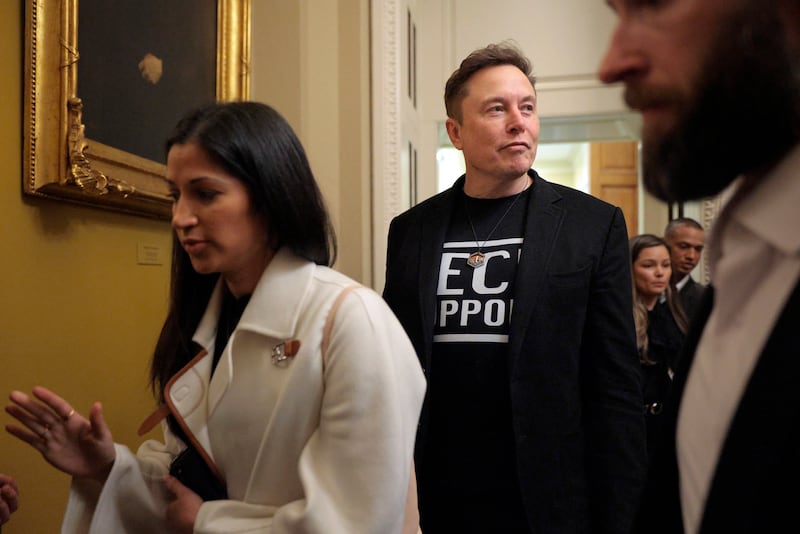 Elon Musk (C) is accompanied by Katie Miller (L) as he leaves a meeting with Senate Republicans in the U.S. Captiol on March 05, 2025.