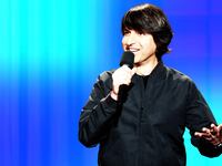 An illustration including a photo of Demetri Martin
