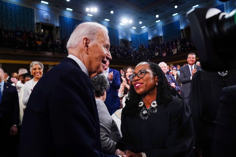 Joe Biden in the well of Congress smiling and shaking hands with Ketanji Brown Jackson.