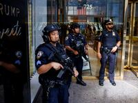 Officers armed with rifles stand outside Trump Tower.