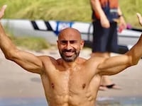 Eiffel Gilyana gives the “hang loose” sign with both hands as he smiles shirtless.