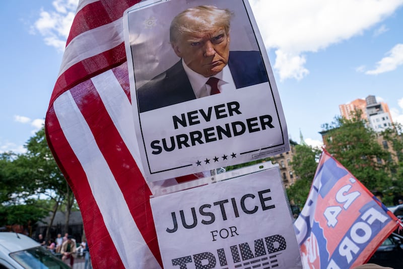 NEW YORK, NEW YORK - MAY 30: A poster of former President Donald Trump is held by one of his supporters after he was found guilty on all counts at Manhattan Criminal Court on May 30, 2024 in New York City. Donald Trump was found guilty on all 34 felony counts of falsifying business records in the first of his criminal cases to go to trial.