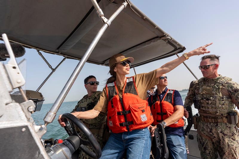 Homeland Security Secretary Kristi Noem (C) pilots an Over the Horizon Small Boat.