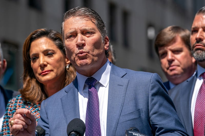 Ronny Jackson in a suit speaking into a micrphone