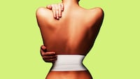 Woman from the back with a very small waist and a bandage around it