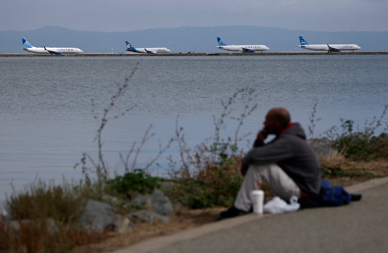 Planes line up on the runway to depart from San Francisco International Airport