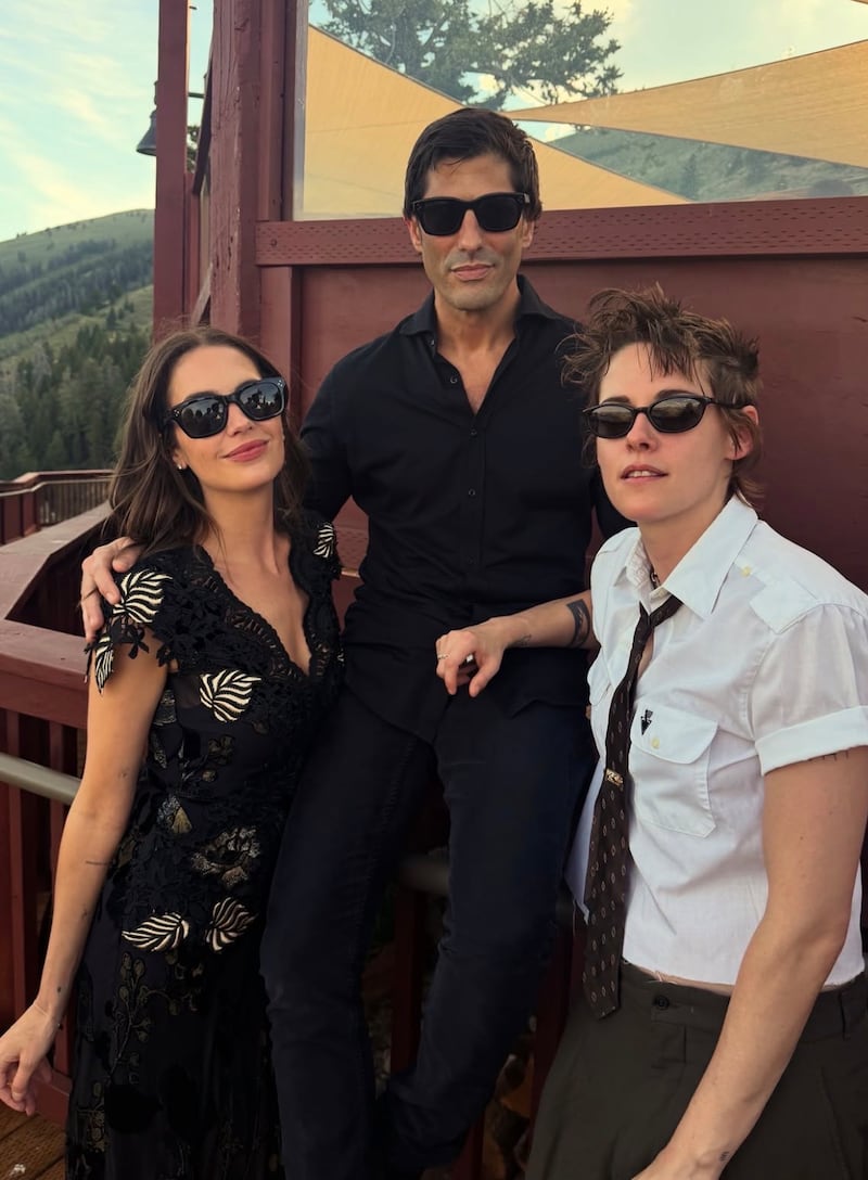 Kristen Stewart wore a white shirt for Emma Roberts’s wedding. Pictured here with actress Ashley Benson and her oil heir husband, Brandon Davis.