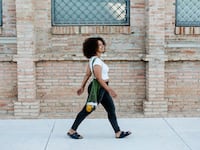 Photo: A woman walking down the street.
