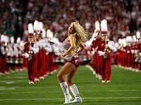 An Alabama Crimson Tide cheerleader performs ahead of the start of the NCAA National Championship college football game against the Notre Dame