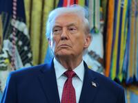 U.S. President Donald Trump listens during a ceremony for the presentation of the Mexican Border Defense Medal in the Oval Office of the White House on December 15, 2025 in Washington, DC.