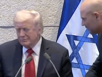An aide tells Trump that it isn't his turn to speak.