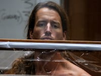 Samuel Haskell IV stands with his chest exposed during a December court hearing for the murder of his wife and in-laws in Los Angeles.