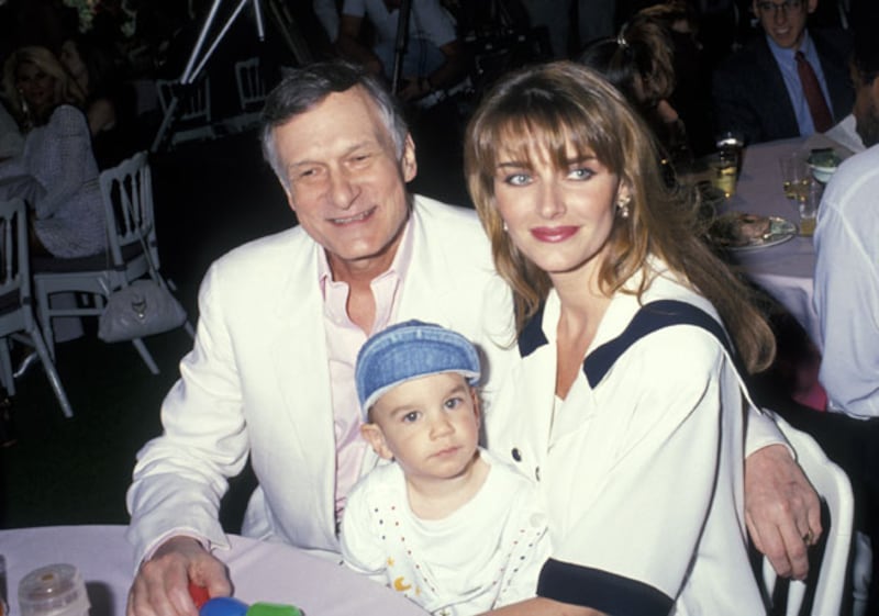 Hugh Hefner with Kimberley Conrad and their son Marston in April 1991.