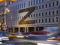 Cars drive past a theater with a “Z” symbol in Moscow, Russia, on Feb. 16, 2023.